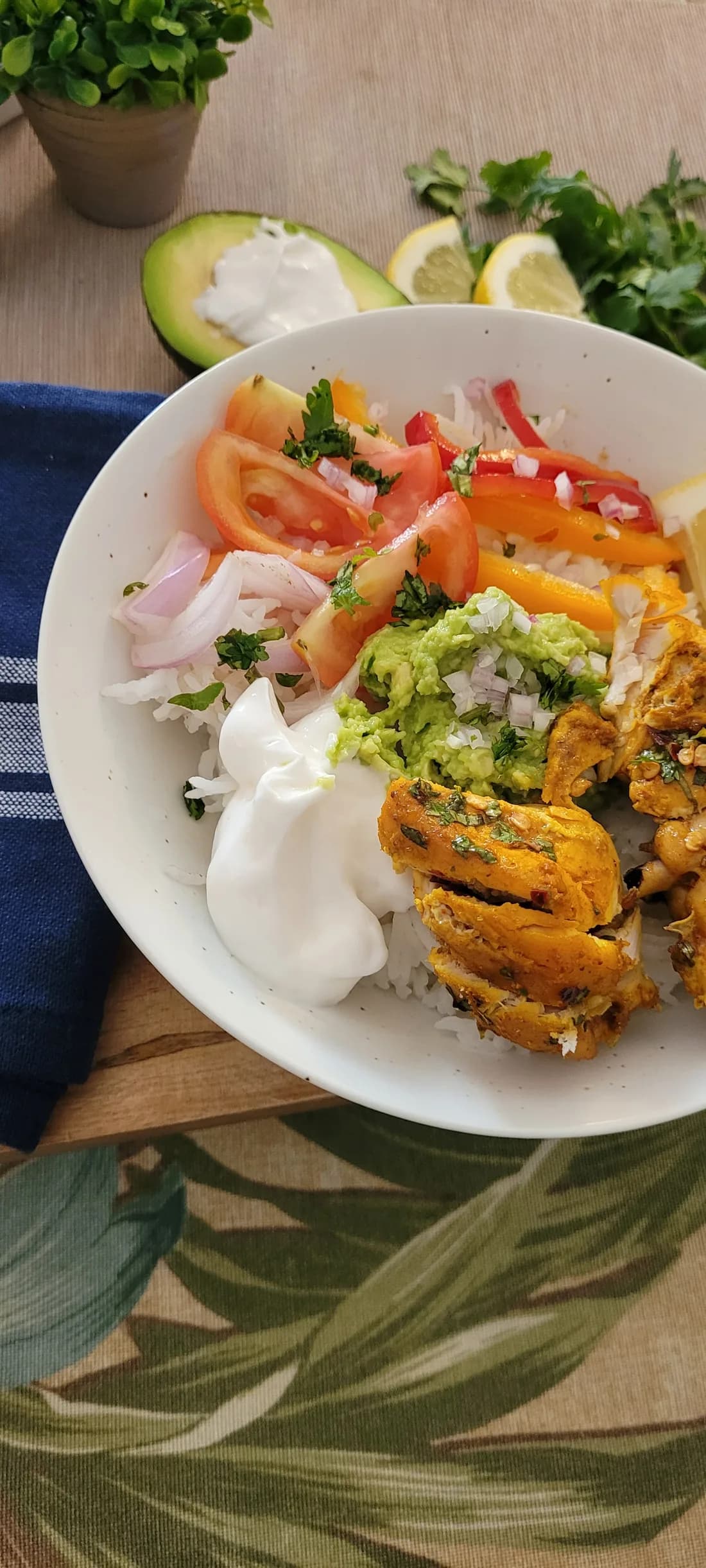 Chicken added to rice, avocado, yogurt, and vegetables