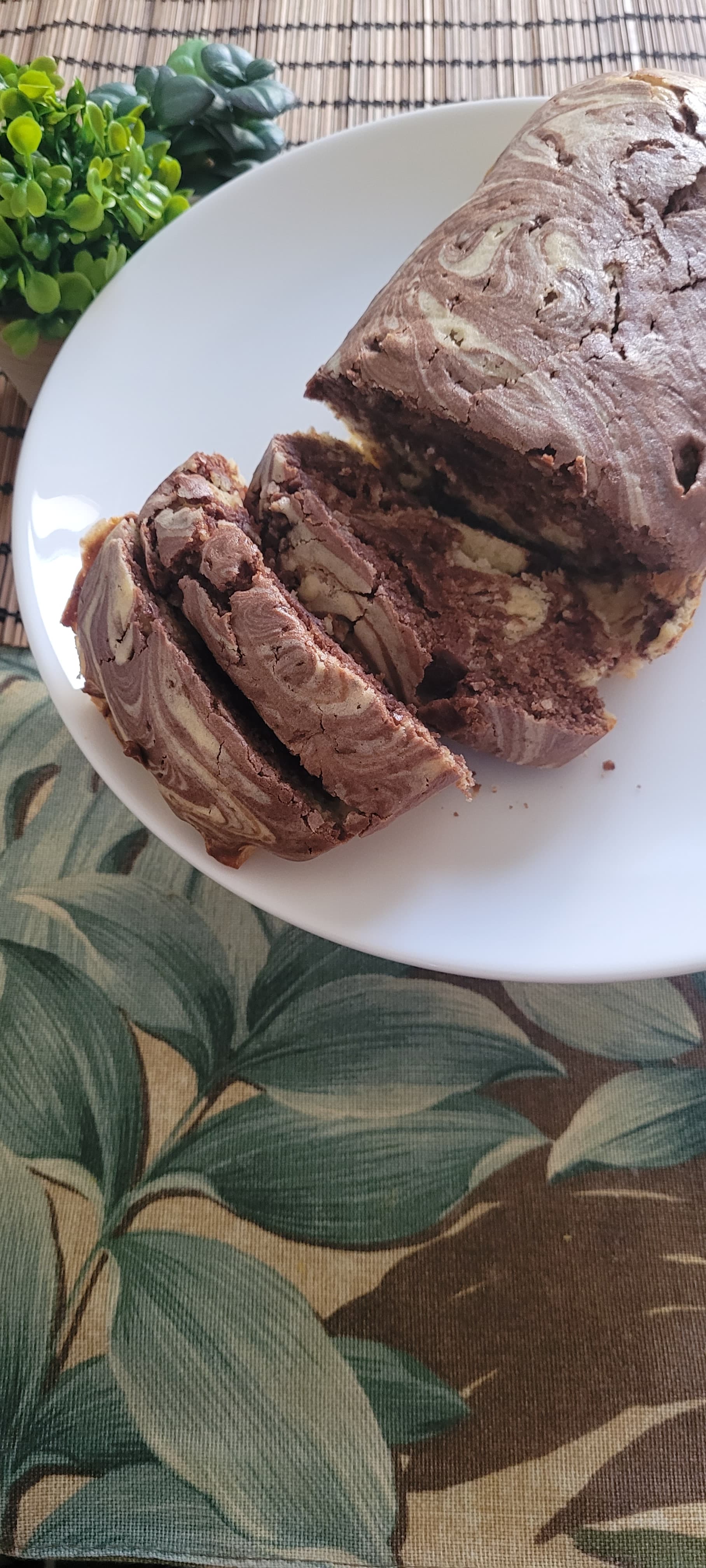 Sliced homemade chocolate and vanilla marble cake on a white plate