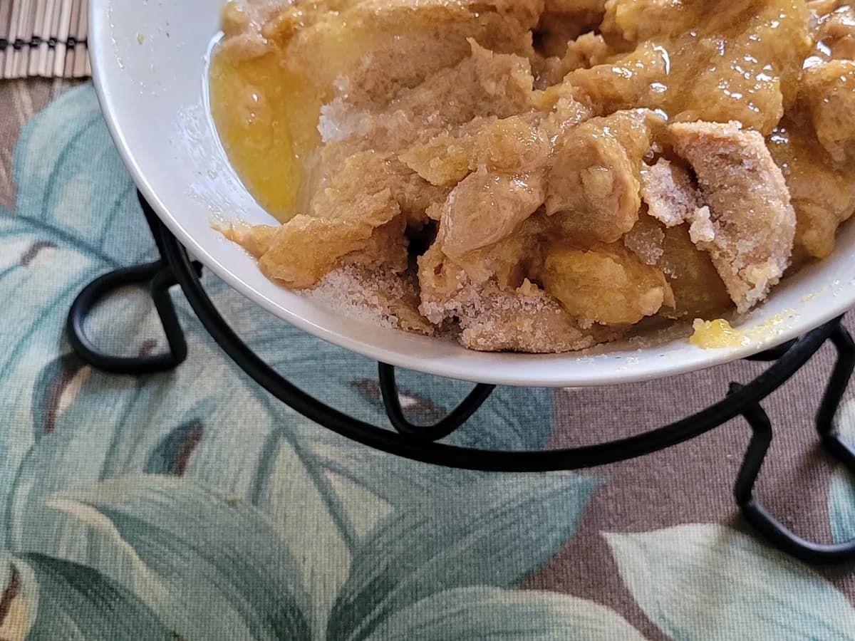 Peanut butter cookie dough being mixed with a spatula